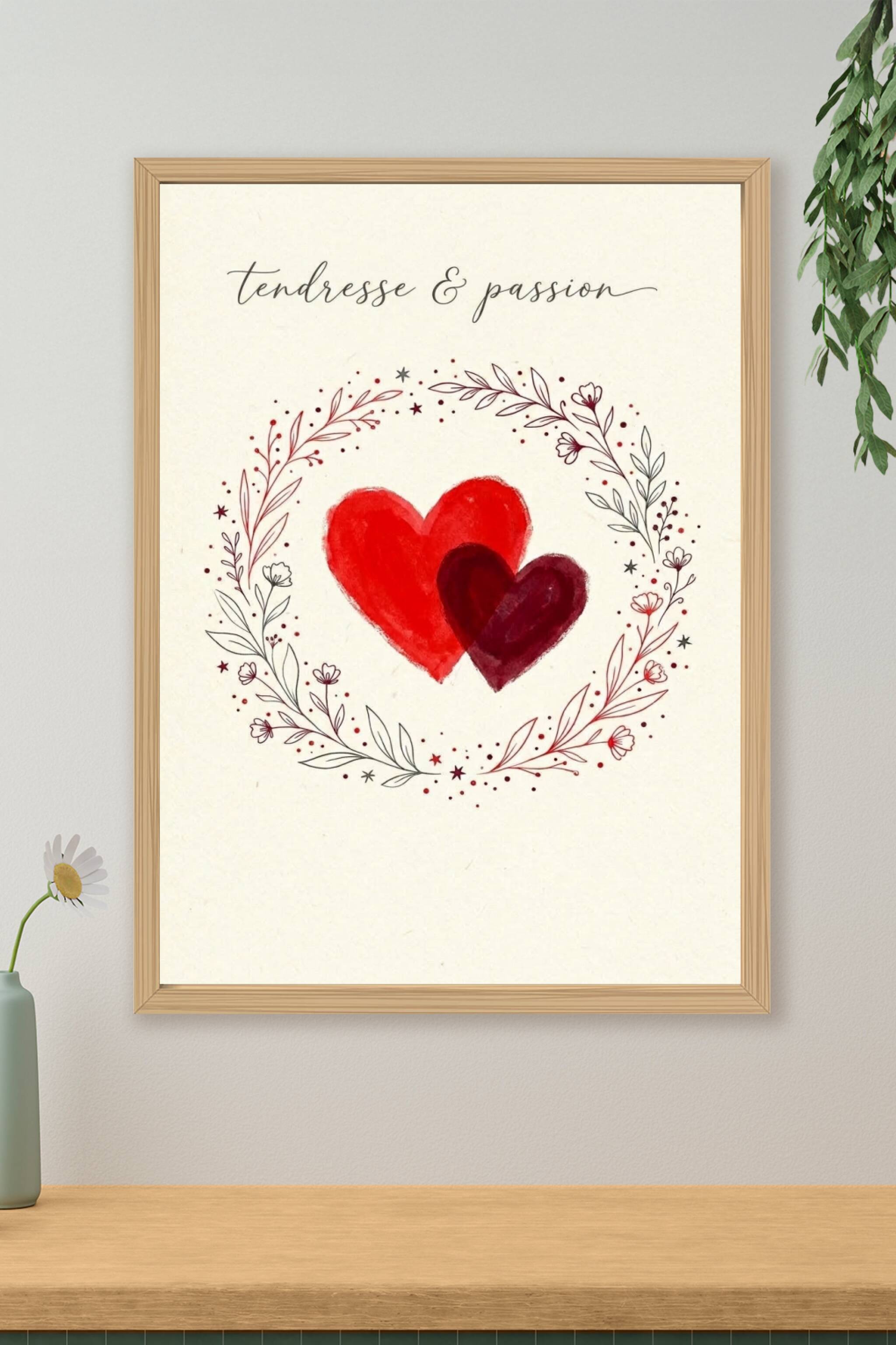 A romantic minimal poster: two overlapping hand-painted hearts in bright red and deep crimson at the centre of a warm...