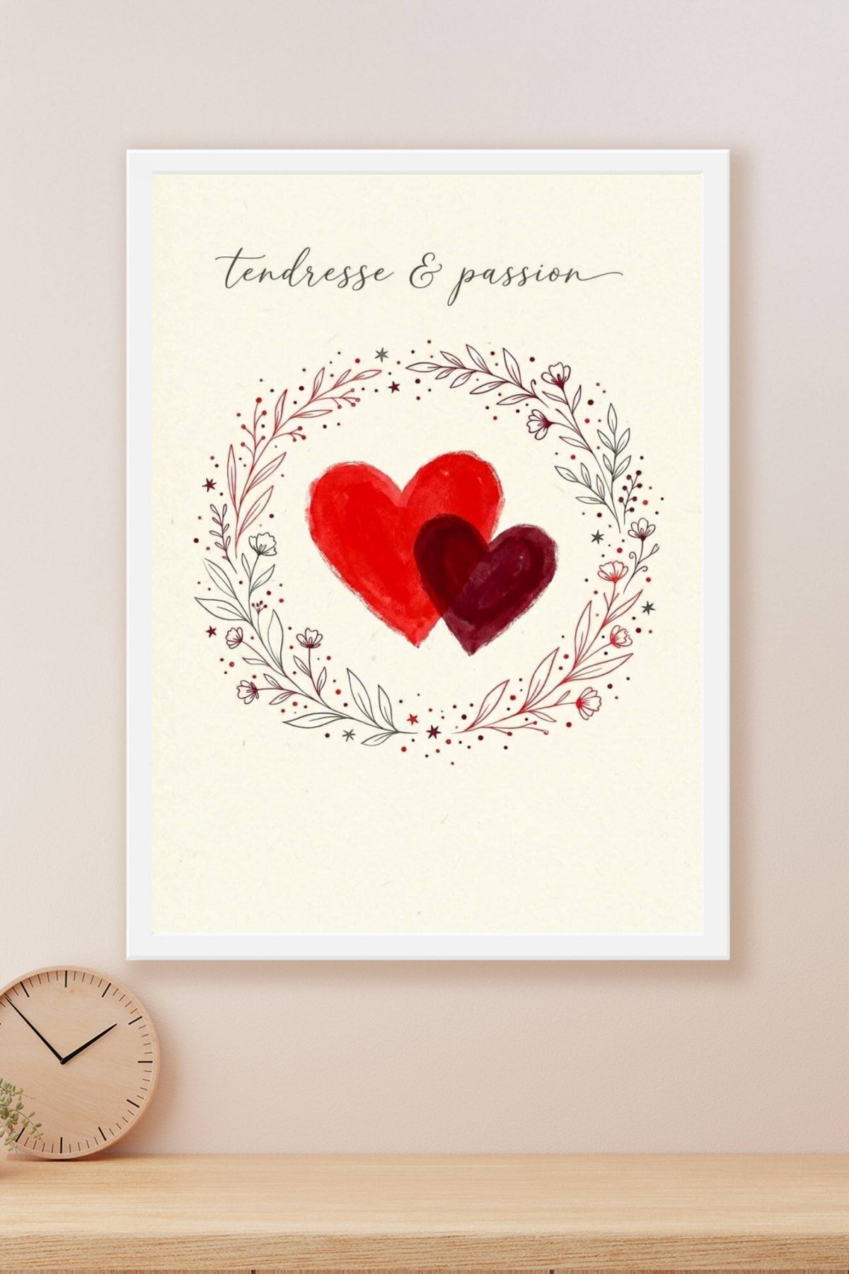 A romantic minimal poster: two overlapping hand-painted hearts in bright red and deep crimson at the centre of a warm...