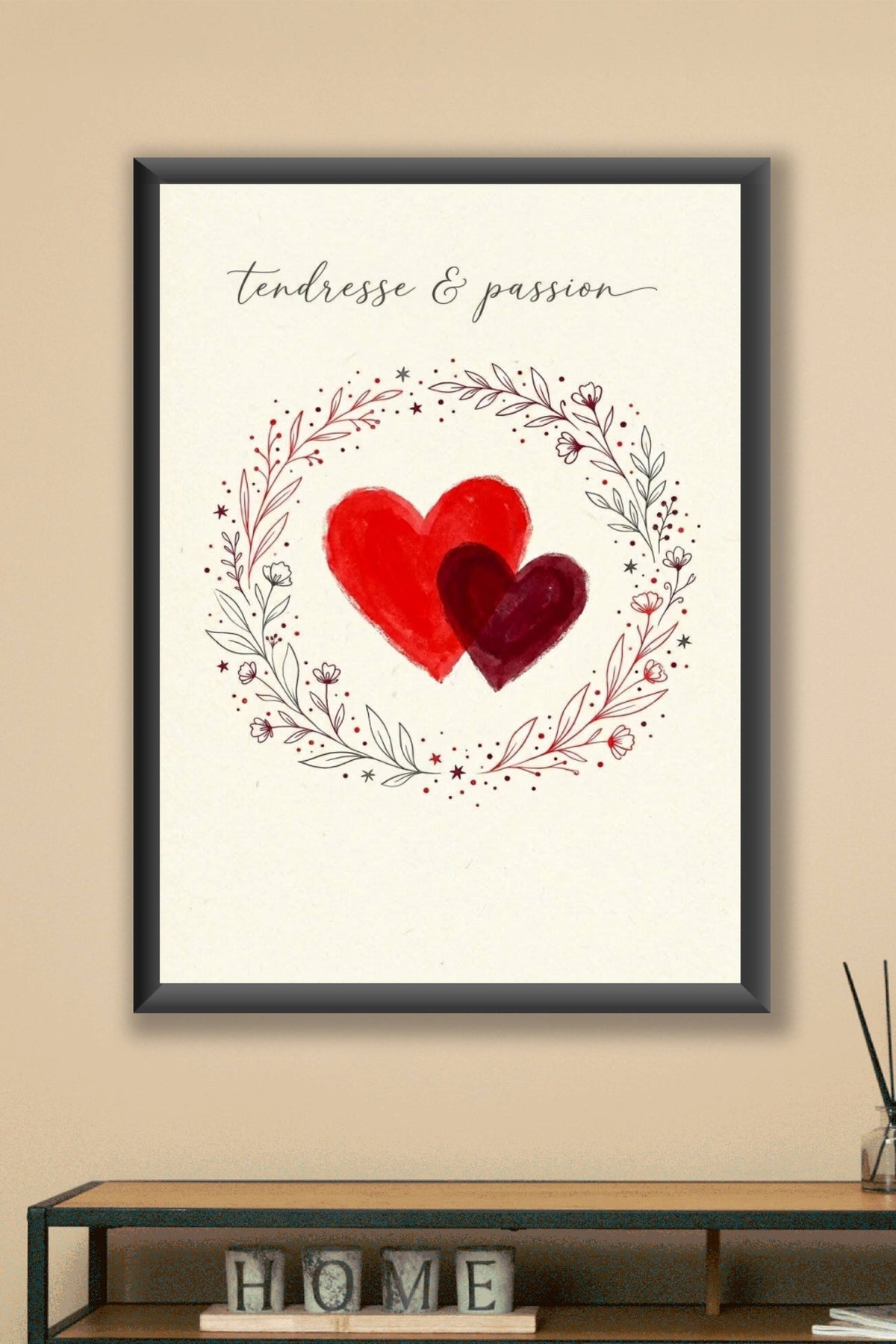 A romantic minimal poster: two overlapping hand-painted hearts in bright red and deep crimson at the centre of a warm...
