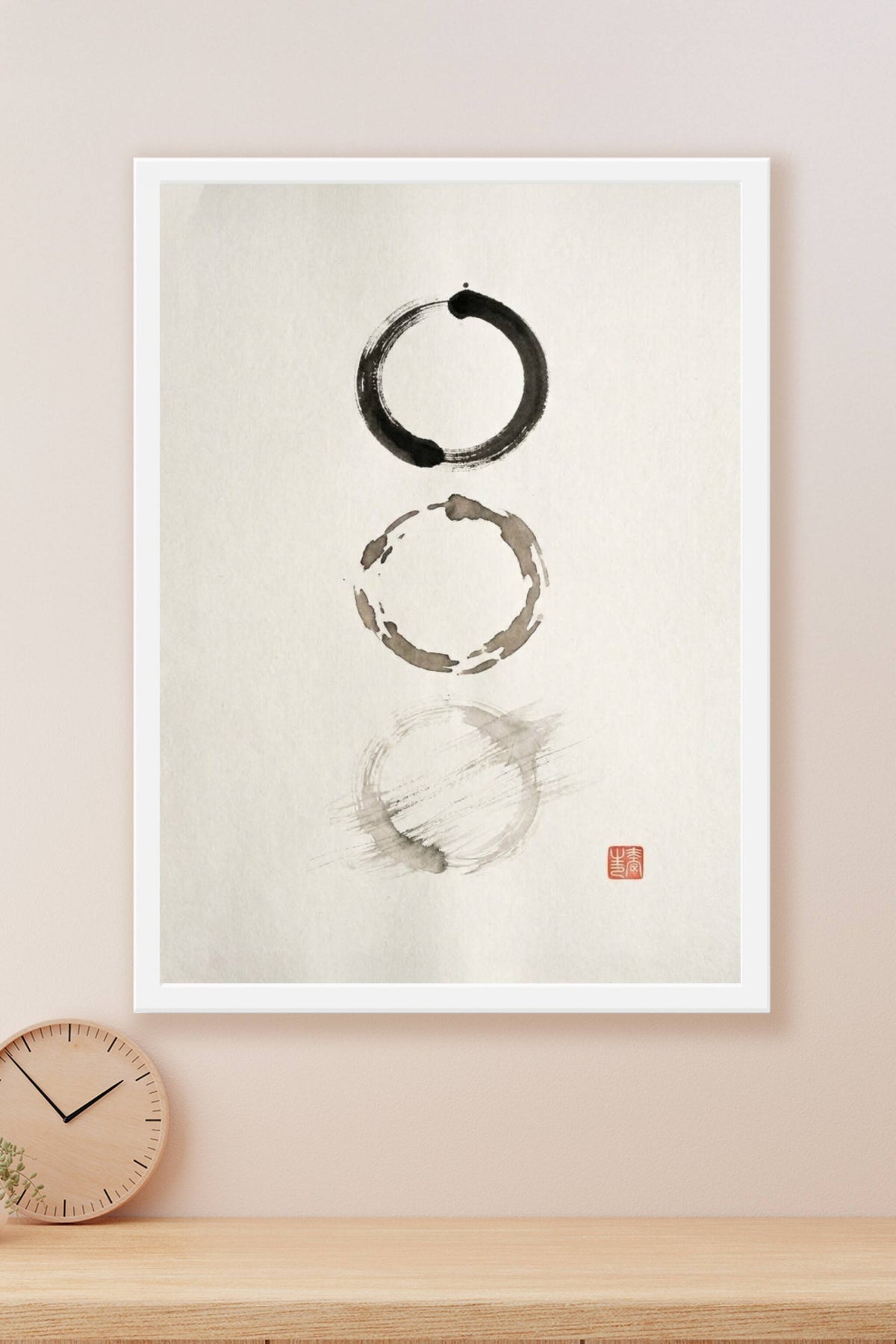 A minimalist sumi-e ink wash artwork showing three imperfect circles arranged vertically on bare paper, each brushed...